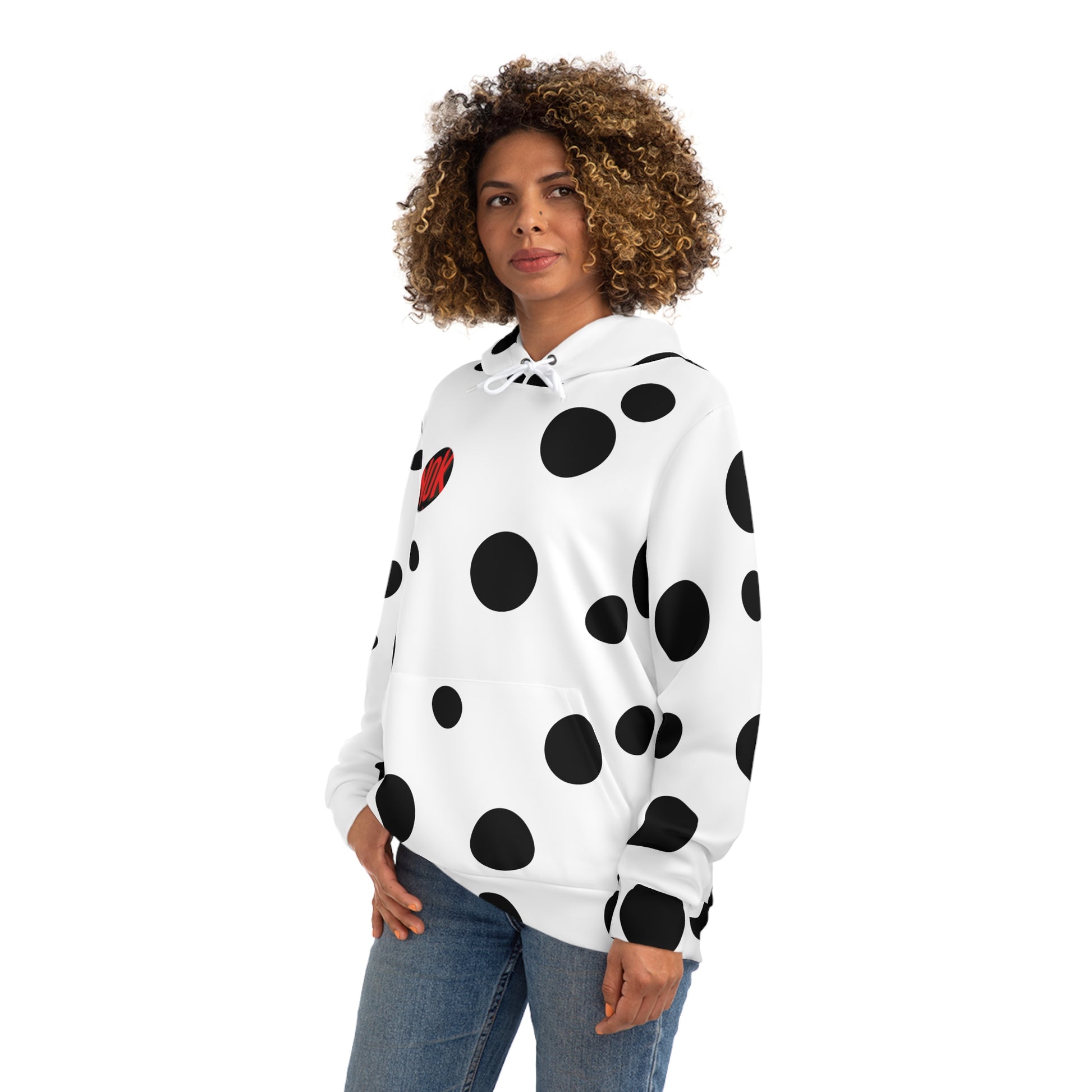 Side view of the white 'Break the Pattern' hoodie with bold black circles, worn by a woman.