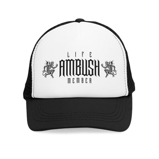 Front view of the Life Ambush Member trucker cap showcasing the bold gothic font and dragon design on the white front panel with a black visor.