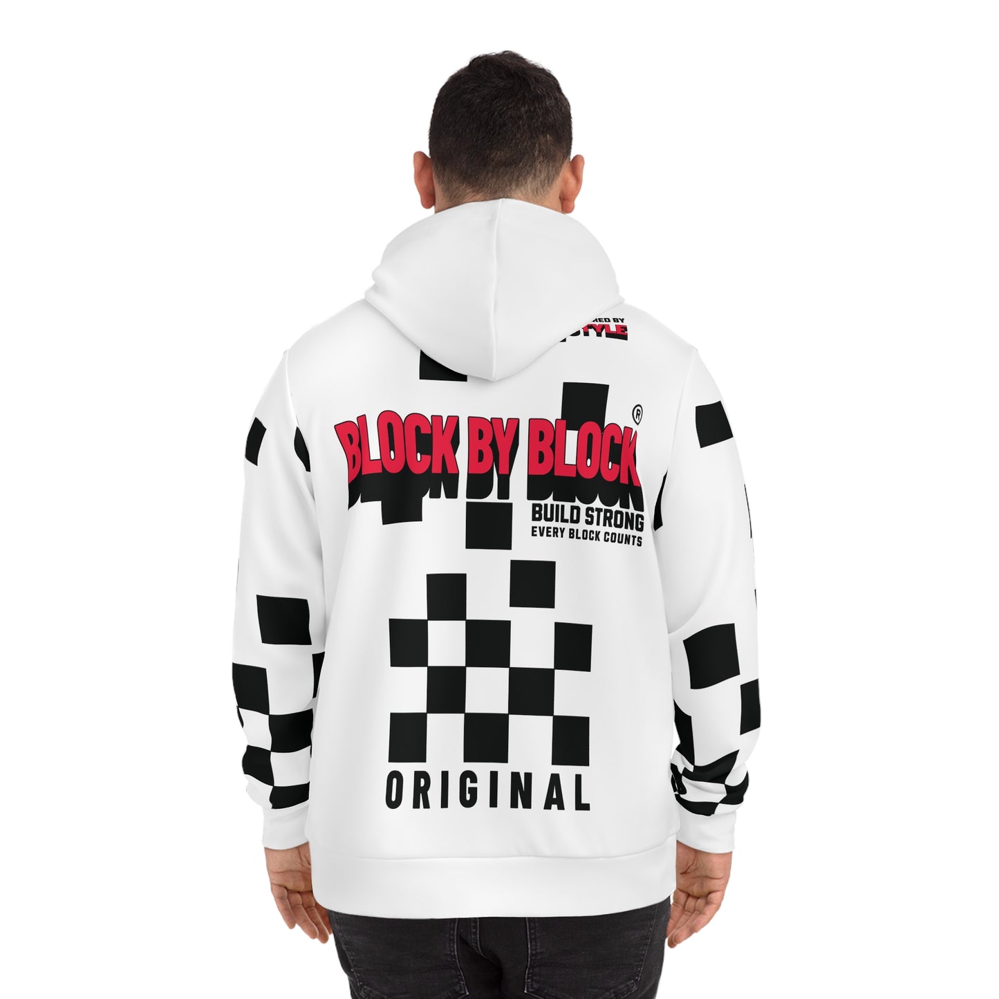 Back view of a man in a white hoodie with a bold red 'Block by Block' logo and black checkered accents.