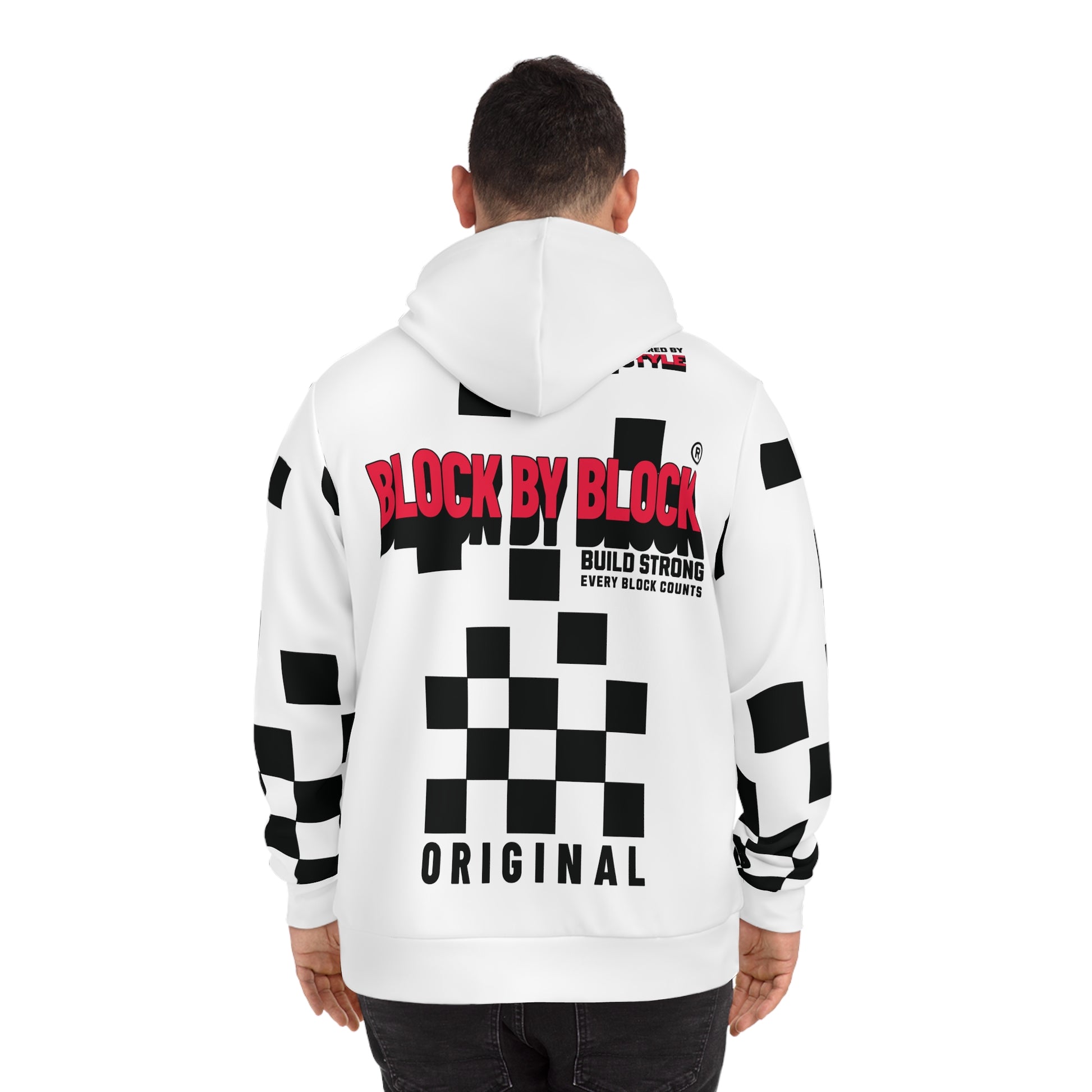 Back view of a man in a white hoodie with a bold red 'Block by Block' logo and black checkered accents.