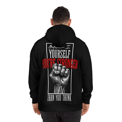 Man wearing a black hoodie, showcasing the back design with a motivational quote and detailed fist artwork.