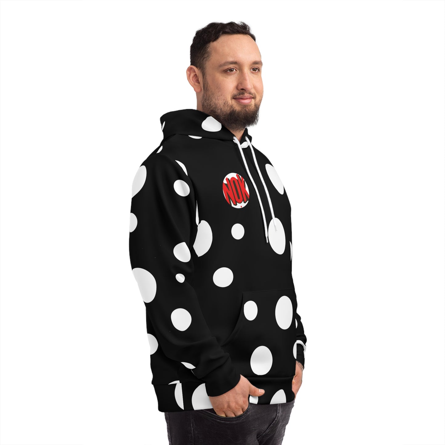 Side view of a man wearing NOK's black hoodie with bold white circular patterns and a striking NOK logo on the chest.