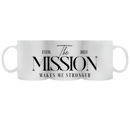 White coffee mug featuring 'The Mission Makes Me Stronger' slogan in bold typography, delivering daily inspiration and resilience with every sip.