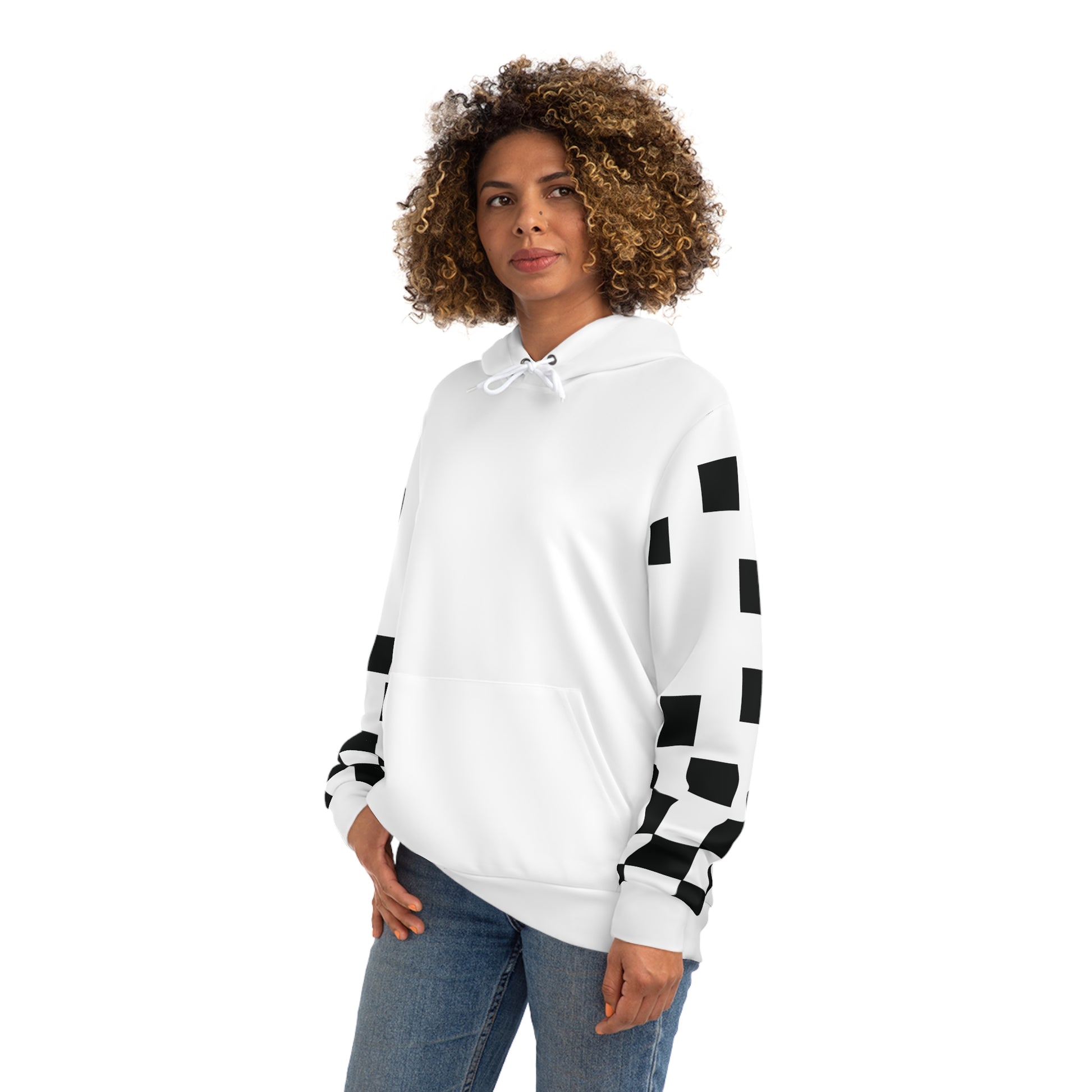 Woman standing in a white hoodie featuring black checkered sleeves, photographed from the front.