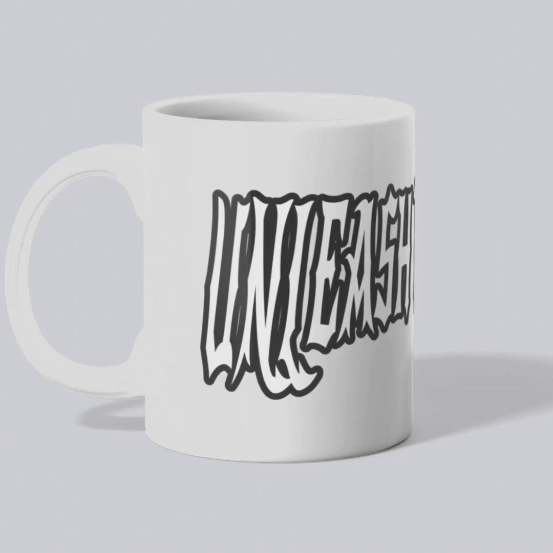 Animated rotating view of the Unleash The Power ceramic mug, displaying the bold text design from all angles.